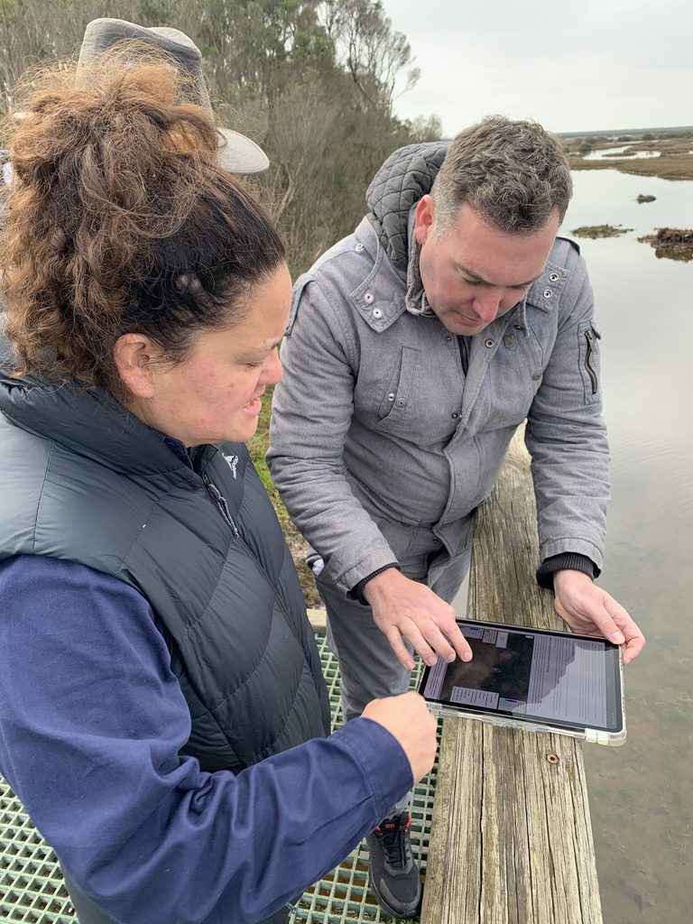 Researcher showing practitioner the flood maps online